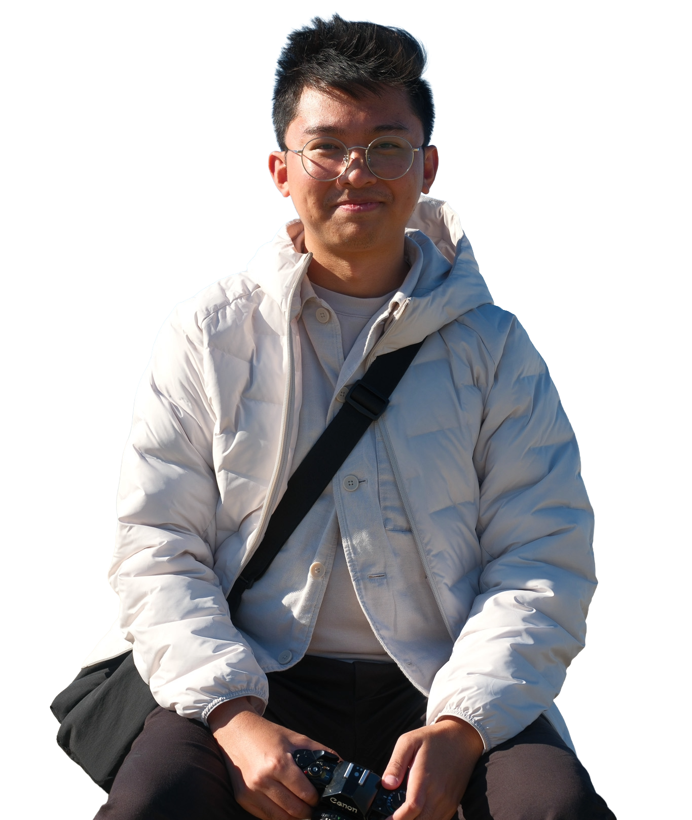 Blaise Cruz seated with a camera